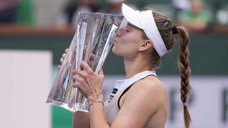 Elena Rybakina, of Kazakhstan, kisses the winner's trophy after defeating Aryna Sabalenka, of Belarus, in the women's singles final at the BNP Paribas Open tennis tournament Sunday, March 19, 2023, in Indian Wells, Calif. (Mark J. Terrill/AP)