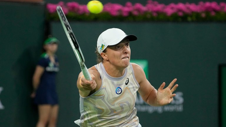 Iga Swiatek, of Poland, returns a shot to Elena Rybakina, of Kazakhstan, during a semifinal match at the BNP Paribas Open tennis tournament Friday, March 17, 2023, in Indian Wells, Calif. (Mark J. Terrill/AP)