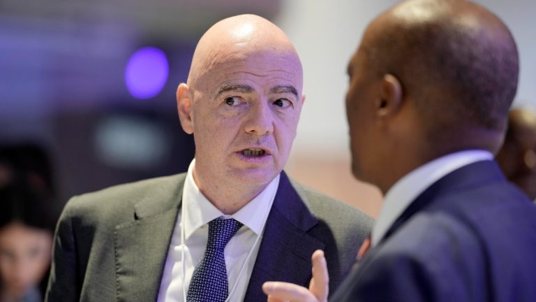 FIFA President Gianni Infantino, left, talks with South African mining businessman Patrice Motsepe, right, at the World Economic Forum in Davos, Switzerland, on Wednesday, Jan. 18, 2023. The annual meeting of the World Economic Forum is taking place in Davos from Jan. 16 until Jan. 20, 2023. (Markus Schreiber/AP)