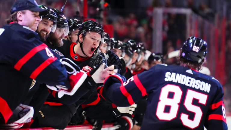 Ottawa Senators left wing Brady Tkachuk (7) shouts at teammate Jake Sanderson (85) as he skates past the bench celebrating his goal against the Detroit Red Wings during second period NHL hockey action in Ottawa on Monday, Feb. 27, 2023. (Sean Kilpatrick/CP)