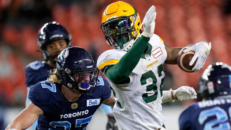 Edmonton Elks running back James Wilder Jr. (32) runs the ball past Toronto Argonauts defensive back Josh Hagerty (27) during second half CFL football action in Toronto, Tuesday, Nov. 16, 2021. (Nathan Denette/CP)