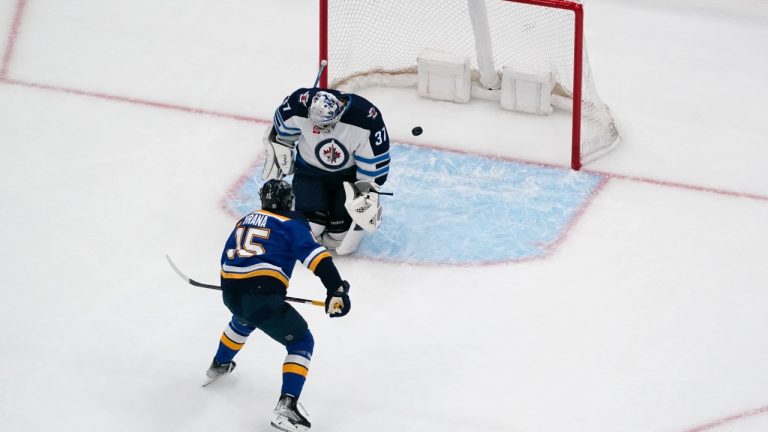 St. Louis Blues' Jakub Vrana (15) scores past Winnipeg Jets goaltender Connor Hellebuyck (37) during the third period of an NHL hockey game Sunday, March 19, 2023, in St. Louis. (Jeff Roberson/AP)