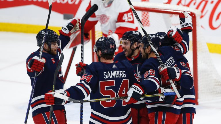 Winnipeg Jets' Adam Lowry (17), Dylan Samberg (54), Dylan DeMelo (2), Nino Niederreiter (62) and Mason Appleton (22) celebrate Niederreiter's goal on Detroit Red Wings goaltender Magnus Hellberg (45) during second period NHL action in Winnipeg, Friday, March 31, 2023. (John Woods/CP)