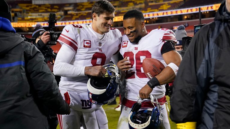 New York Giants quarterback Daniel Jones and running back Saquon Barkley  walk off the field after a 20-12 victory over the Washington Commanders, Sunday, Dec. 18, 2022, in Landover, Md. (Susan Walsh/AP)