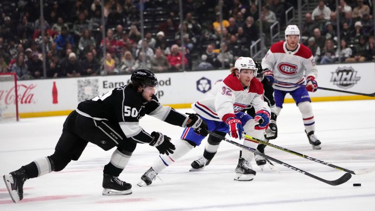 Montreal Canadiens center Rem Pitlick (32) reaches for the puck as Los Angeles Kings' Sean Durzi (50) defends during the first period of an NHL hockey game Thursday, March 2, 2023, in Los Angeles. (Marcio Jose Sanchez/AP)