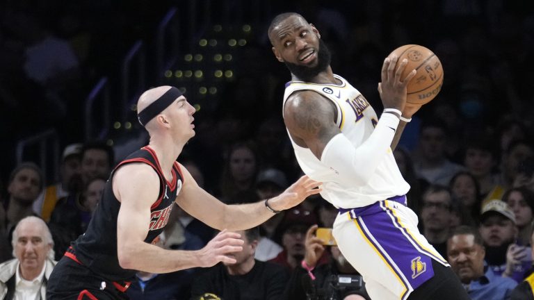 Los Angeles Lakers forward LeBron James, right, is defended by Chicago Bulls guard Alex Caruso during the first half of an NBA basketball game, Sunday, March 26, 2023, in Los Angeles. (Marcio Jose Sanchez/AP)