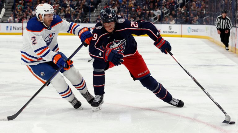 Columbus Blue Jackets forward Patrik Laine, right, reaches for the puck in front of Edmonton Oilers defenseman Evan Bouchard during the second period of an NHL hockey game in Columbus, Ohio, Saturday, Feb. 25, 2023. (Paul Vernon/AP)