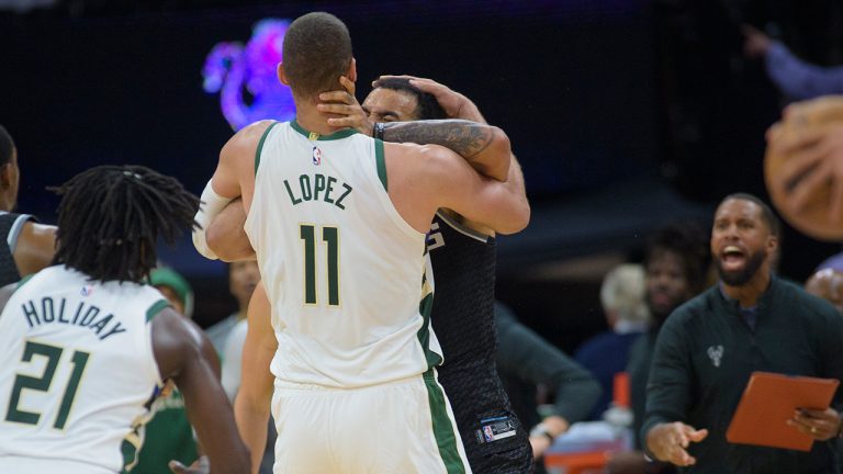 Milwaukee Bucks center Brook Lopez (11) and Sacramento Kings forward Trey Lyles scuffle in the final seconds of the second half of an NBA basketball game in Sacramento, Calif., Monday, March 13, 2023. Both players were ejected from the game. (Randall Benton/AP)