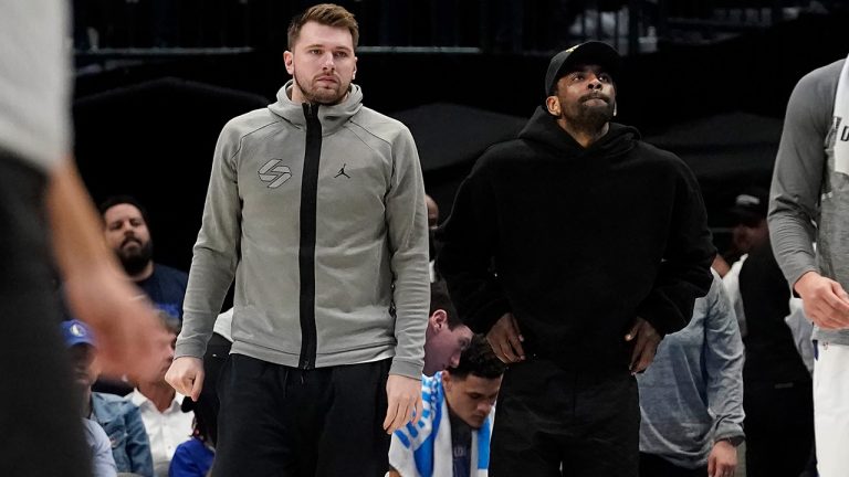 Dallas Mavericks' Luka Doncic, left, and Kyrie Irving look on from the sideline during the second half of an NBA basketball game against the Memphis Grizzlies in Dallas, Monday, March 13, 2023. (LM Otero/AP)