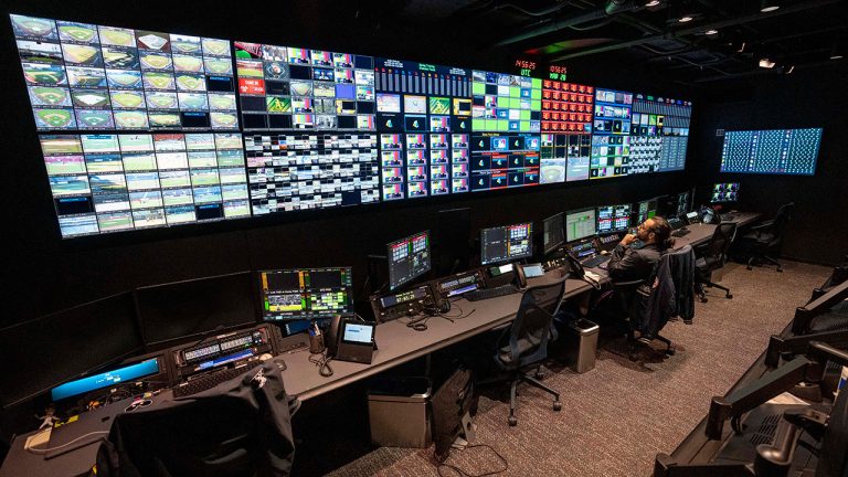 Employees operate workstations inside the broadcast support room at Major League Baseball headquarters in New York, Tuesday, March 28, 2023. (John Minchillo/AP)