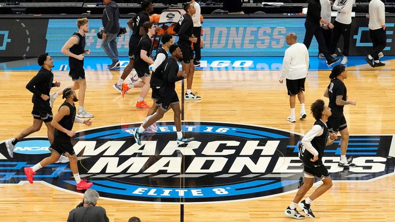 The Providence men's basketball team warm up over the March Madness logo during practice for the NCAA men's college basketball tournament Thursday, March 24, 2022, in Chicago.  (Charles Rex Arbogast/AP)