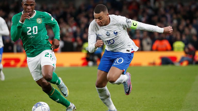 France's Kylian Mbappe, right, and Ireland's Chiedozie Ogbene compete for the ball during the Euro 2024 group B qualifying soccer match between Ireland and France at the Aviva Stadium in Dublin, Ireland, Monday, March 27, 2023. (Peter Morrison/AP)