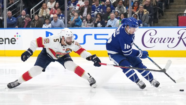 Toronto Maple Leafs forward Mitchell Marner (16) drives to the net as Florida Panthers defenceman Aaron Ekblad (5) defends during second period NHL hockey action in Toronto on Tuesday, January 17, 2023. (Nathan Denette/CP)