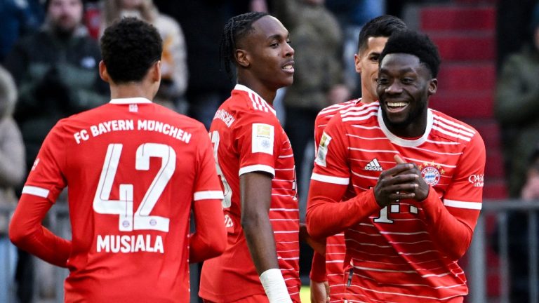 Munich's Alphonso Davies, right, celebrates scoring with teammate Jamal Musiala during a German Bundesliga match between FC Bayern Munich and FC Augsburg in Munich, Germany, Saturday, March 11, 2023. (Sven Hoppe/dpa via AP)