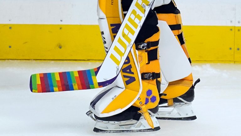 Los Angeles Kings goaltender Calvin Petersen (40) holds a stick wrapped in rainbow tape for Pride night while warming up before an NHL hockey game Monday, April 26, 2021, in Los Angeles. (Ashley Landis/AP)