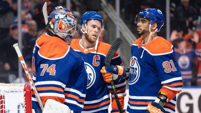 Edmonton Oilers' goalie Stuart Skinner (74), Connor McDavid (97) and Evander Kane (91) celebrate their shutout win over the Los Angeles Kings in NHL action in Edmonton on Thursday March 30, 2023. (Jason Franson/CP)