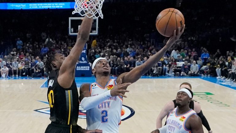 Oklahoma City Thunder guard Shai Gilgeous-Alexander (2) shoots in front of Golden State Warriors forward Jonathan Kuminga, left, in the first half of an NBA basketball game Tuesday, March 7, 2023, in Oklahoma City. (Sue Ogrocki/AP)