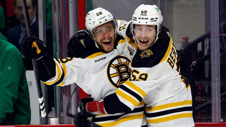 Boston Bruins' David Pastrnak (88) celebrates after his goal with teammate Tyler Bertuzzi (59) during the first period of an NHL hockey game against the Carolina Hurricanes in Raleigh, N.C., Sunday, March 26, 2023. (Karl B DeBlaker/AP)