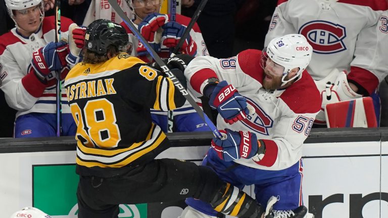 Boston Bruins right wing David Pastrnak (88) and Montreal Canadiens defenseman David Savard (58) collide during the first period of an NHL hockey game, Thursday, March 23, 2023, in Boston. (Steven Senne/AP)