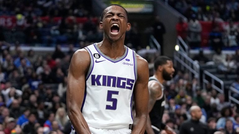 Sacramento Kings guard De'Aaron Fox, left, celebrates after scoring as Los Angeles Clippers forward Marcus Morris Sr. stands in the background during the second half of an NBA basketball game Friday, Feb. 24, 2023, in Los Angeles. (Mark J. Terrill/AP)