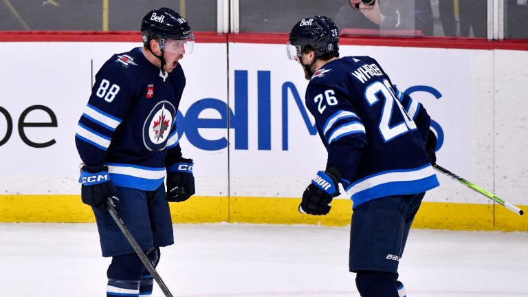 Winnipeg Jets' Nate Schmidt (88) celebrates his goal against the San Jose Sharks with Blake Wheeler (26) during third period NHL action in Winnipeg on Monday March 6, 2023. (Fred Greenslade/CP)