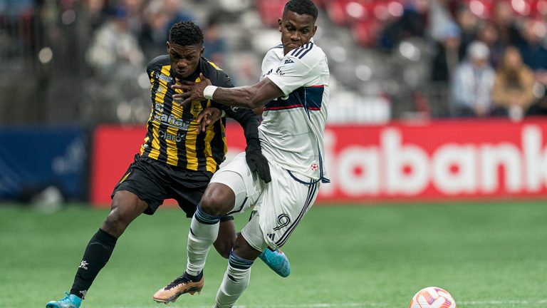 Vancouver Whitecaps FC's Sergio Cordova (right) tries to fight off Real Espana's Franklin Flores while trying to control the ball during second half CONCACAF Champions League soccer action in Vancouver, B.C., Wednesday, March 8, 2023. (Rich Lam/CP)