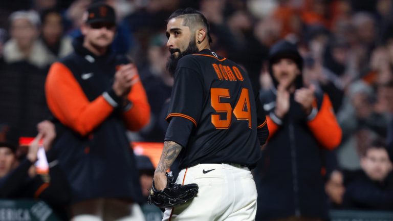 San Francisco Giants pitcher Sergio Romo (54) walks back to the dugout after being removed during the seventh inning of a spring training baseball game against the Oakland Athletics in San Francisco, Monday, March 27, 2023. (Jed Jacobsohn/AP)