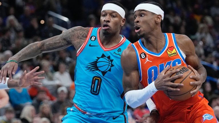 Oklahoma City Thunder guard Shai Gilgeous-Alexander, right, drives around Phoenix Suns forward Torrey Craig (0) in the first half of an NBA basketball game Sunday, March 19, 2023, in Oklahoma City. (Sue Ogrocki/AP)