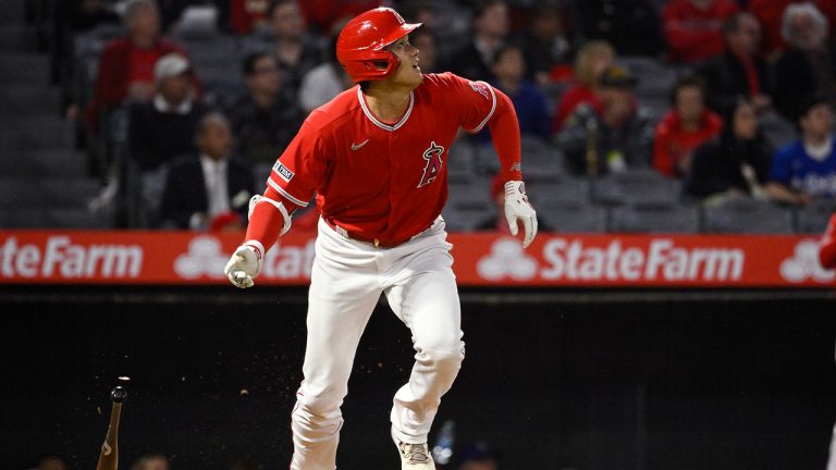 Los Angeles Angels' Shohei Ohtani runs to first as he hits a single during the fifth inning of a preseason baseball game against the Los Angeles Dodgers Monday, March 27, 2023, in Anaheim, Calif. (Mark J. Terrill/AP)