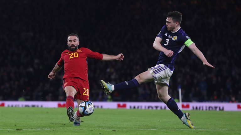 Spain's Dani Carvajal, left, challenges for the ball with Scotland's Andrew Robertson during the Euro 2024 group A qualifying soccer match between Scotland and Spain at the Hampden Park stadium in Glasgow, Scotland, Tuesday, March 28, 2023. (Scott Heppell/AP)