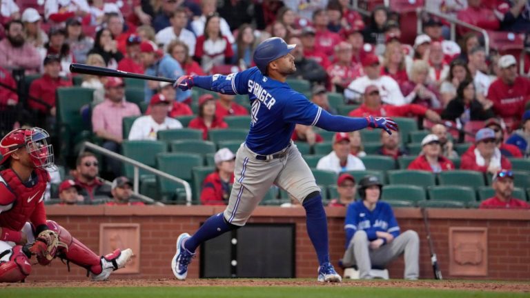 Toronto Blue Jays' George Springer follows through on an RBI single during the ninth inning of an opening day baseball game Thursday, March 30, 2023, in St. Louis. (Jeff Roberson/AP Photo)