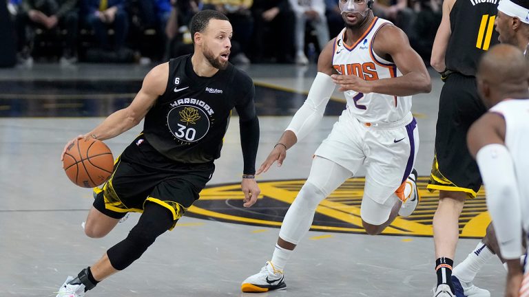 Golden State Warriors guard Stephen Curry drives to the basket against Phoenix Suns forward Josh Okogie during the first half of an NBA basketball game in San Francisco, Monday, March 13, 2023. (Jeff Chiu/AP)