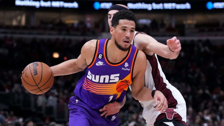 Phoenix Suns' Devin Booker drives past Chicago Bulls' Alex Caruso during the first half of an NBA basketball game Friday, March 3, 2023, in Chicago. (Charles Rex Arbogast/AP)