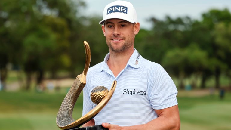 Taylor Moore holds the trophy after winning the Valspar Championship golf tournament Sunday, March 19, 2023, at Innisbrook in Palm Harbor, Fla. (Mike Carlson/AP)