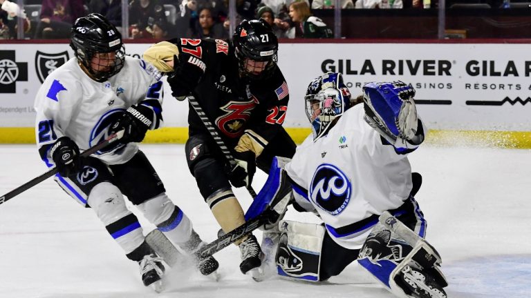 Toronto Six forward Shiann Darkangelo (27) battles Minnesota Whitecaps' Amanda Boulier (28) in front of the Whitecaps goalie Amanda Leveille during the Isobel Cup Championship action in Tempe, Arizona on Sunday March 26, 2023. (Kate Free/ Premier Hockey Federation via CP)