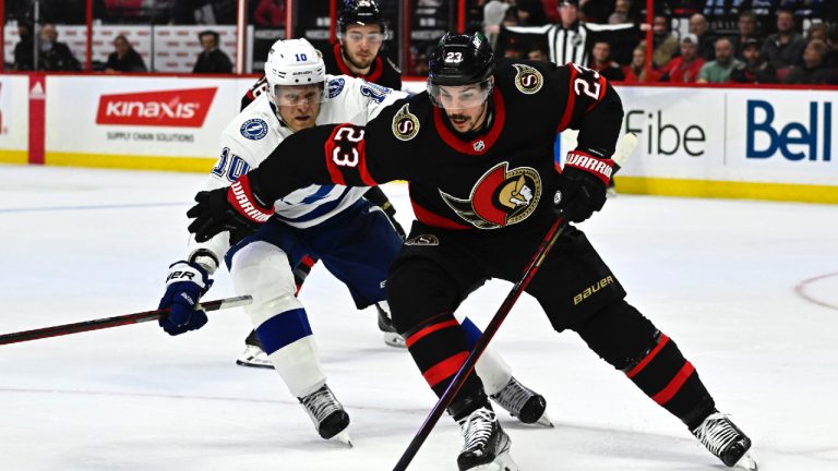 Ottawa Senators defenceman Travis Hamonic (23) keeps Tampa Bay Lightning right wing Corey Perry (10) away from the puck during first period NHL hockey action in Ottawa, Thursday, March 23, 2023. (Justin Tang/CP)