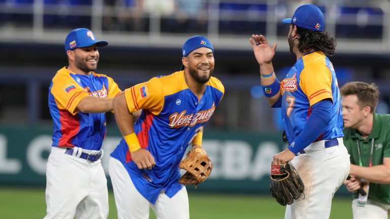 Venezuela third baseman Eugenio Suarez (7), right fielder Anthony Santander (25), center and second baseman Jose Altuve (27) celebrate after defeating Nicaragua 4-1 at a World Baseball Classic game, Tuesday, March 14, 2023, in Miami. (Marta Lavandier/AP)