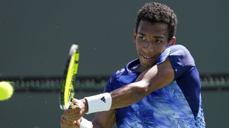 Félix Auger-Aliassime, of Canada, returns to Francisco Cerundolo, of Argentina, at the BNP Paribas Open tennis tournament Monday, March 13, 2023, in Indian Wells, Calif. (Mark J. Terrill/AP)