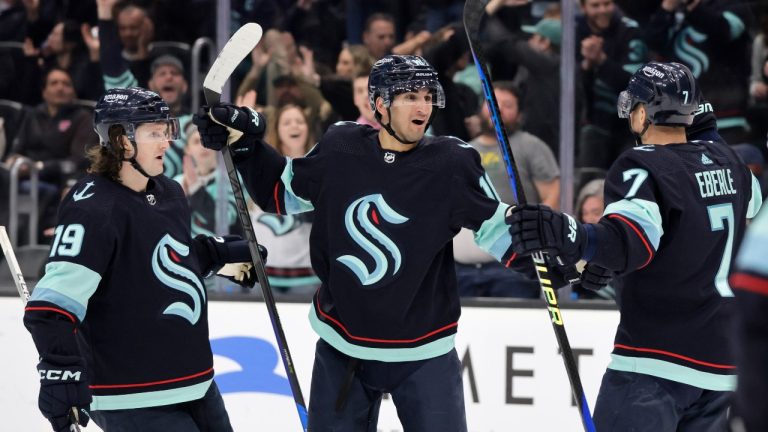 Seattle Kraken center Matty Beniers (10), center, celebrates with left wing Jared McCann (19) and right wing Jordan Eberle (7) after his goal against the Dallas Stars during the second period of an NHL hockey game, Saturday, March 11, 2023, in Seattle. (John Froschauer/AP Photo)