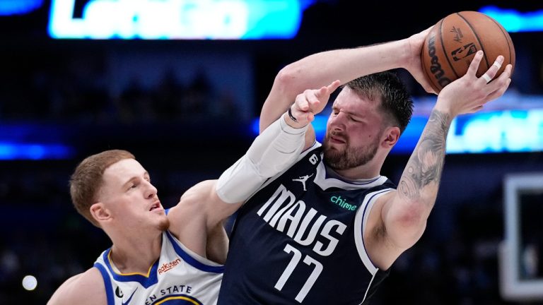 Dallas Mavericks guard Luka Doncic (77) looks for an opportunity to the basket as Golden State Warriors guard Donte DiVincenzo (0) defends in the second half of an NBA basketball game, Wednesday, March 22, 2023, in Dallas. (Tony Gutierrez/AP)