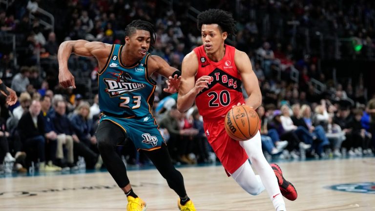 Toronto Raptors guard Jeff Dowtin Jr. (20) drives on Detroit Pistons guard Jaden Ivey (23) in the first half of an NBA basketball game in Detroit, Saturday, Feb. 25, 2023. (Paul Sancya/AP)