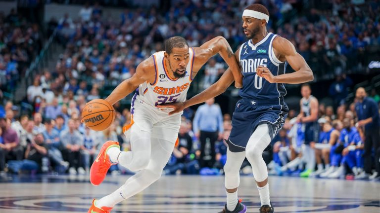 Phoenix Suns forward Kevin Durant (35) drives to the basket while being defended by Dallas Mavericks forward Justin Holiday (0) during the second half of an NBA basketball game, Sunday, March 5, 2023, in Dallas. (Gareth Patterson/AP)