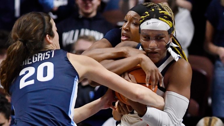 UConn's Aaliyah Edwards, right, fights for possession of the ball against Villanova's Maddy Siegrist, left, and Villanova's Christina Dalce, back center, during the first half of an NCAA college basketball game in the finals of the Big East Conference tournament, Monday, March 6, 2023, in Uncasville, Conn. (Jessica Hill/AP Photo)