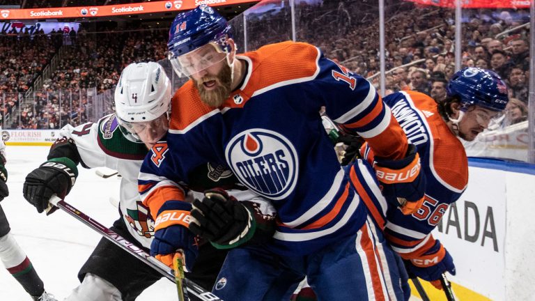 Arizona Coyotes' Juuso Valimaki (4) and Edmonton Oilers' Mattias Ekholm (14) battle for the puck during second period NHL action. (Jason Franson/CP)