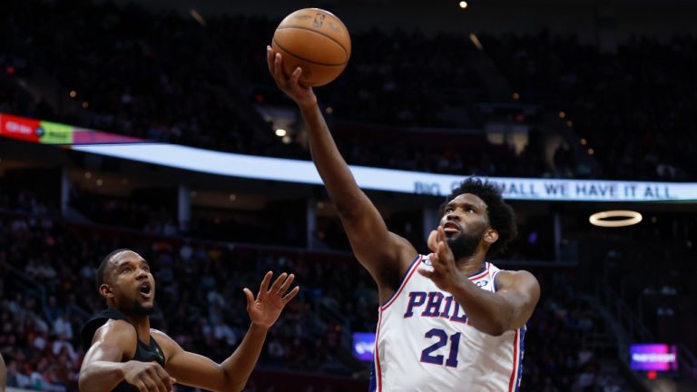 Philadelphia 76ers centre Joel Embiid (21) shoots against Cleveland Cavaliers forward Evan Mobley during the second half of an NBA basketball game, Wednesday, March 15, 2023, in Cleveland. (Ron Schwane/AP)