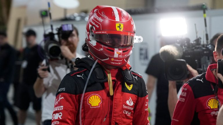 Ferrari driver Charles Leclerc of Monaco walks back to the pit lane after his car stalled in action during the Formula One Bahrain Grand Prix at Sakhir circuit. (Frank Augstein/AP)