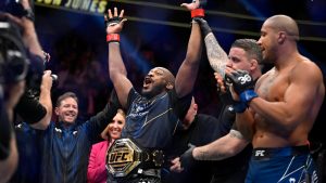 Jon Jones, center, celebrates after defeating Ciryl Gane in a UFC 285 mixed martial arts heavyweight title bout Saturday, March 4, 2023, in Las Vegas. (David Becker/AP)