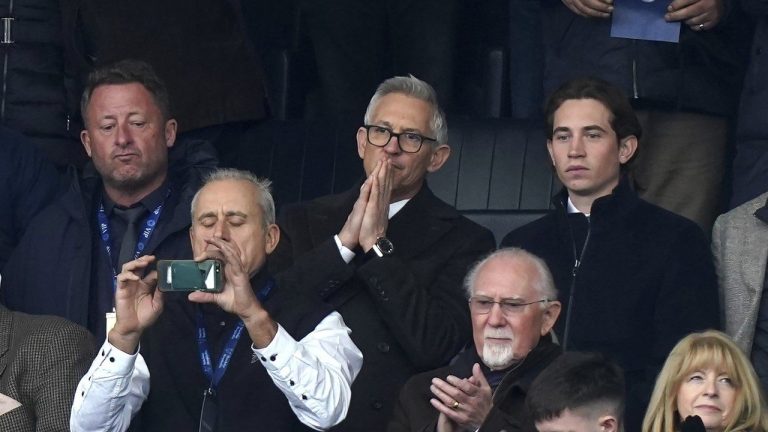 Soccer broadcaster Gary Lineker, centre, gestures, during the English Premier League soccer match between Leicester City and Chelsea at the King Power Stadium, in Leicester, England, Saturday March 11, 2023. (Mike Egerton/PA via AP)