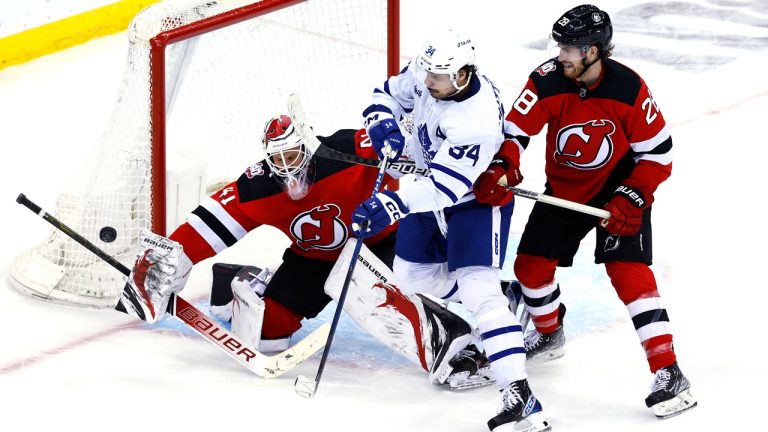 New Jersey Devils goaltender Vitek Vanecek (41) and defenseman Damon Severson (28) defend against Toronto Maple Leafs center Auston Matthews (34) during the third period of an NHL hockey game. (Noah K. Murray/AP)