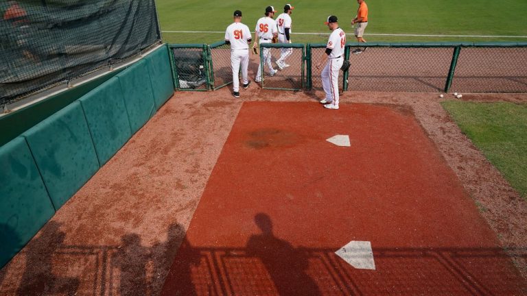 Shadows of fans fall onto the Baltimore Orioles bullpen at the end of a spring training baseball game against the Pittsburgh Pirates in Sarasota, Fla., Wednesday, March 8, 2023. (Gerald Herbert/AP Photo)